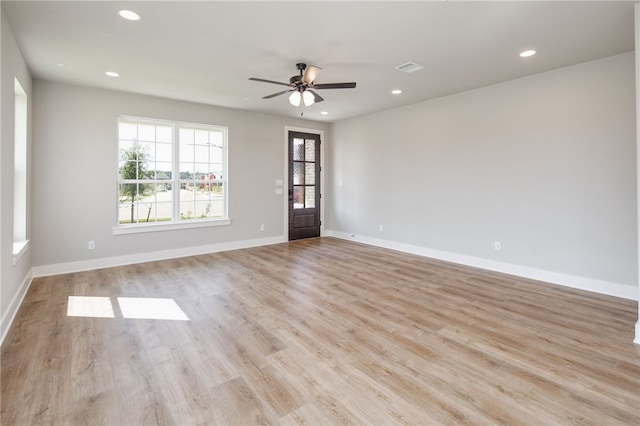 spare room featuring ceiling fan and light hardwood / wood-style flooring