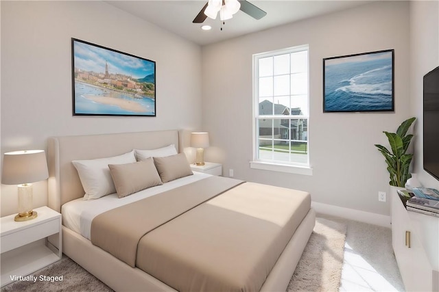 bedroom with light carpet and ceiling fan