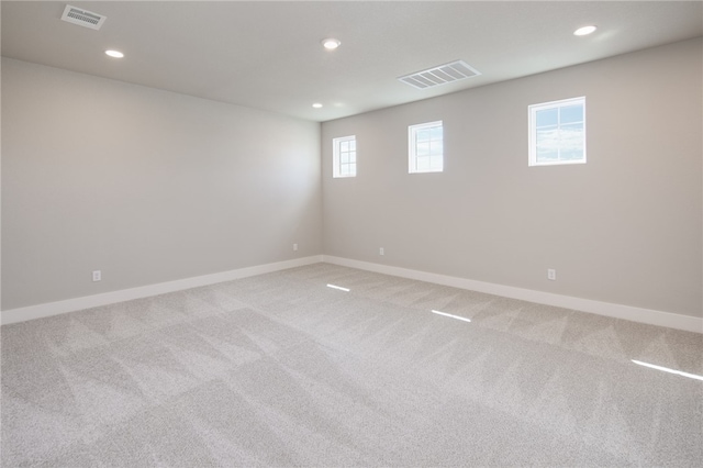 spare room with light colored carpet and a wealth of natural light