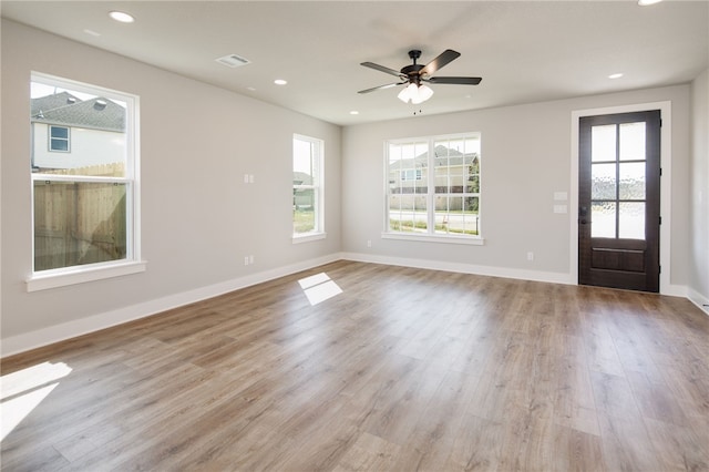 foyer with ceiling fan and light hardwood / wood-style flooring