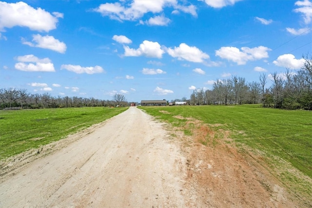 view of street featuring driveway and a rural view