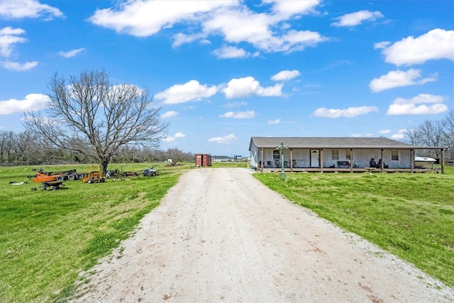 view of front of home featuring driveway and a front lawn