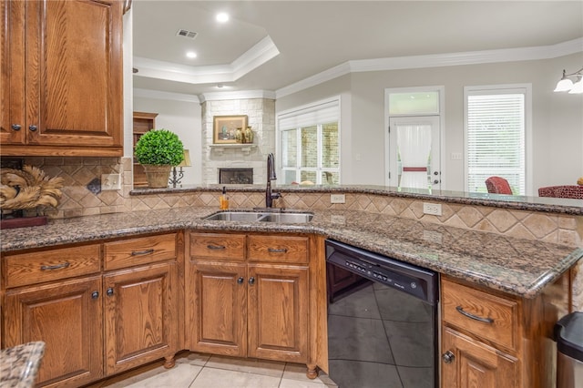 4309 Berwick Pl, College Station, TX 77845 - kitchen featuring dishwasher, a sink, brown cabinetry, light tile patterned floors, and dark stone counters