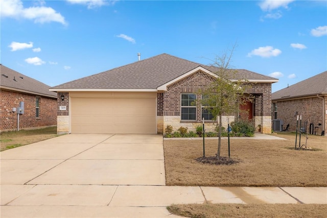 view of front of property with a garage, central AC, and a front lawn