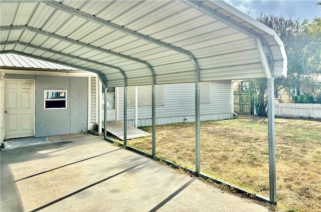 view of parking / parking lot featuring a carport and a lawn