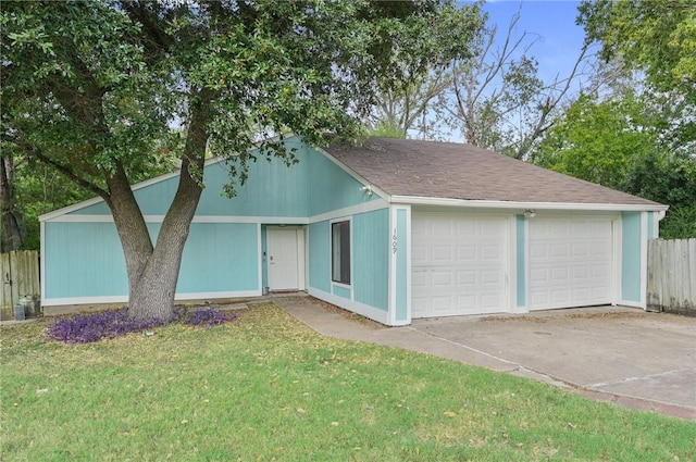 view of front of home featuring a garage, a front yard, roof with shingles, and fence