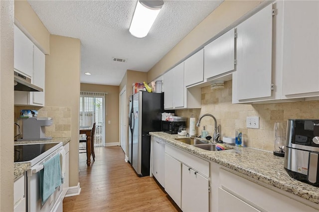 kitchen with white cabinets, sink, stainless steel appliances, and exhaust hood