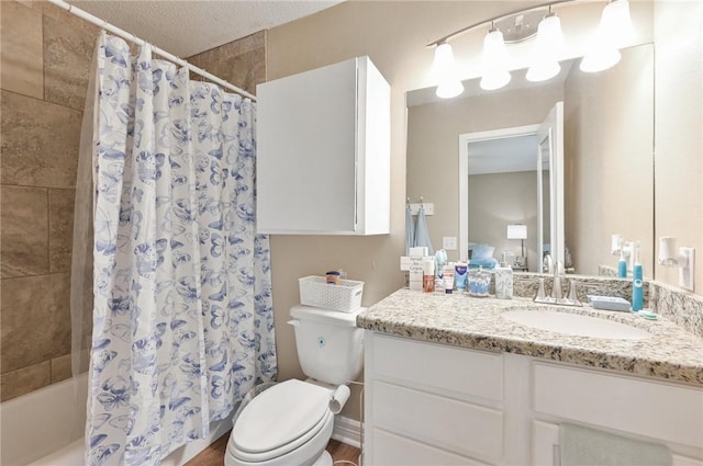 bathroom with vanity, hardwood / wood-style floors, a textured ceiling, and toilet