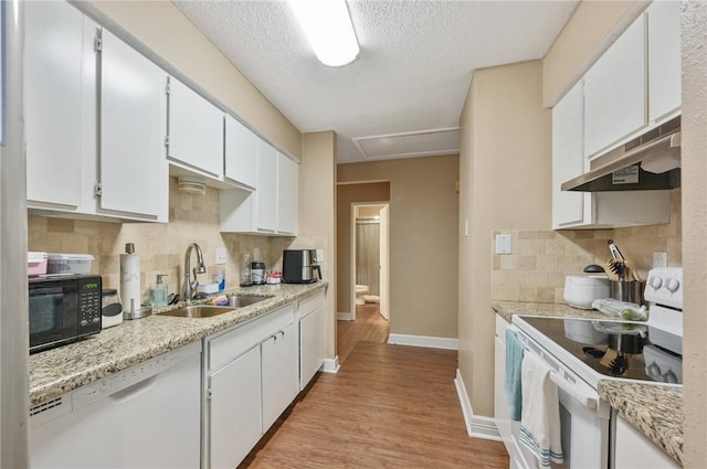 kitchen with sink, light hardwood / wood-style flooring, a textured ceiling, white appliances, and white cabinets