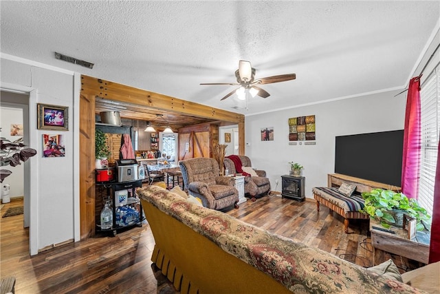 117 S Judge Hailey Dr, Lott, TX 76656 - living room with a textured ceiling, visible vents, hardwood / wood-style flooring, and a ceiling fan