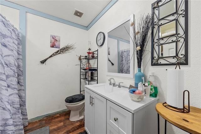 117 S Judge Hailey Dr, Lott, TX 76656 - bathroom featuring curtained shower, visible vents, toilet, wood finished floors, and vanity
