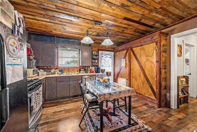 117 S Judge Hailey Dr, Lott, TX 76656 - kitchen with a sink, light countertops, wooden ceiling, stainless steel range with gas stovetop, and white microwave