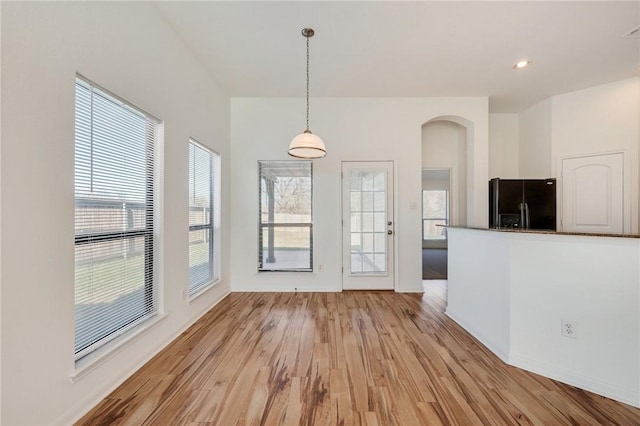 unfurnished dining area with light hardwood / wood-style flooring