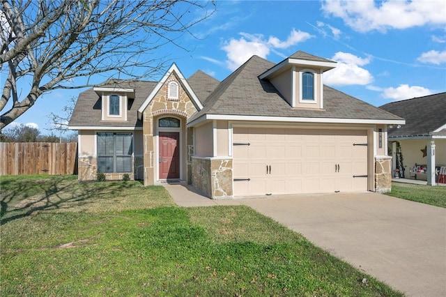 view of front of home with a garage and a front lawn