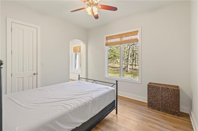 bedroom with ceiling fan and wood-type flooring