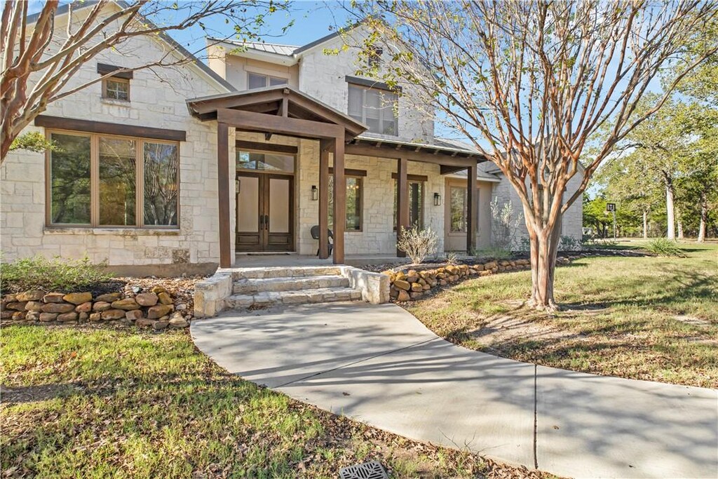 view of front of home with a porch and a front lawn