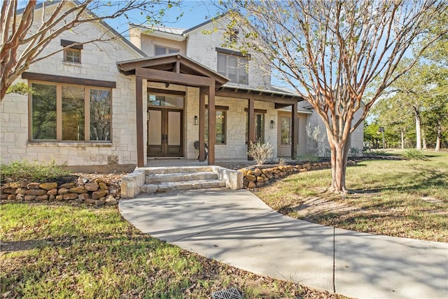 view of front of home with a porch and a front lawn