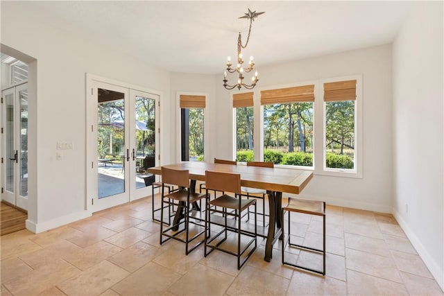 dining room with an inviting chandelier and french doors