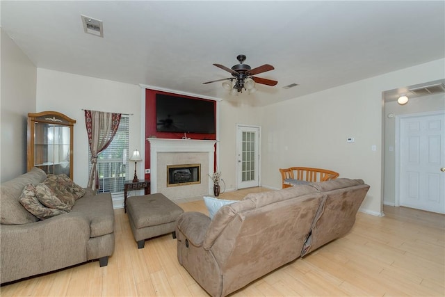 living room featuring light hardwood / wood-style floors and ceiling fan