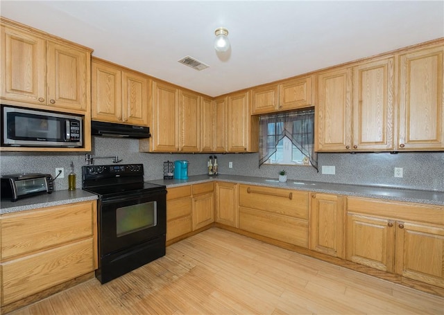 kitchen featuring light wood-type flooring and black range with electric stovetop