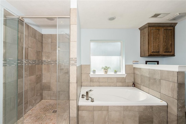 bathroom featuring shower with separate bathtub