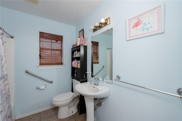 bathroom with sink, tile patterned flooring, and toilet