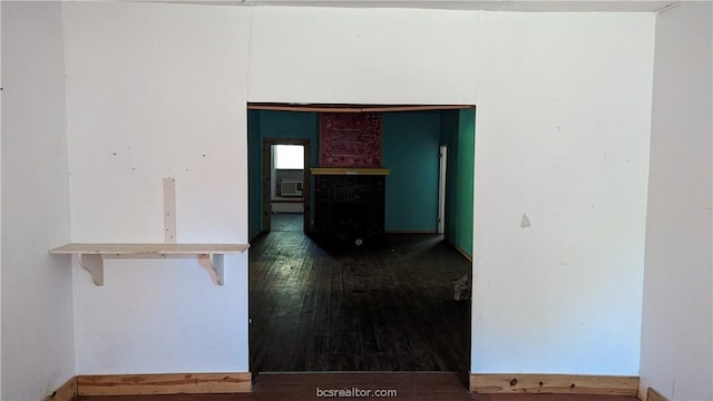 unfurnished room featuring dark wood-type flooring