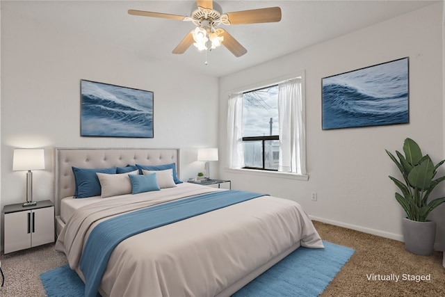 bedroom featuring light colored carpet and ceiling fan