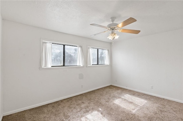 spare room with ceiling fan, carpet flooring, and a textured ceiling