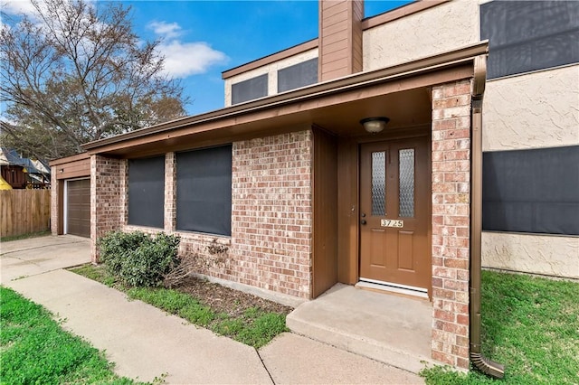 doorway to property with a garage