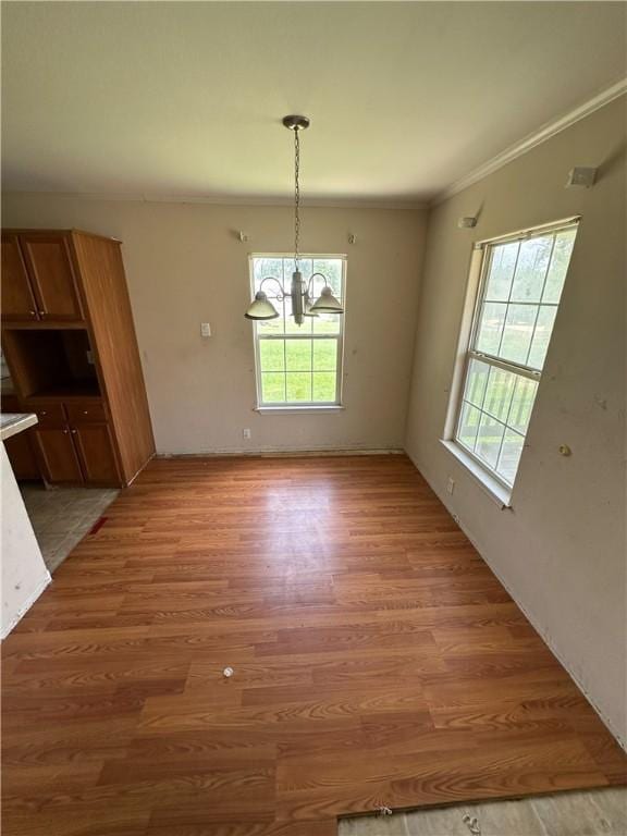 1508 Clark St, Bryan, TX 77808 - unfurnished dining area featuring healthy amount of natural light, light wood-type flooring, a chandelier, and crown molding