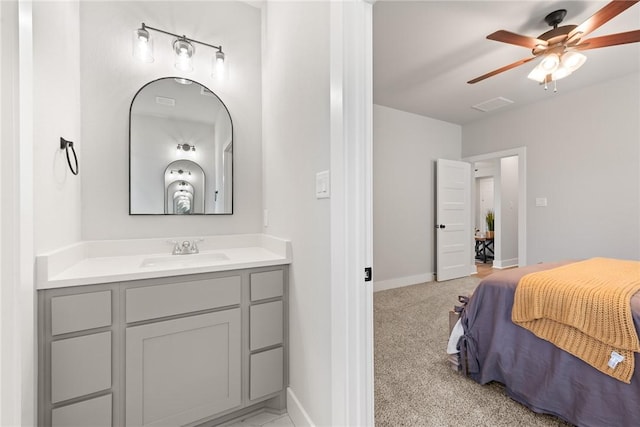 carpeted bedroom featuring ceiling fan and sink