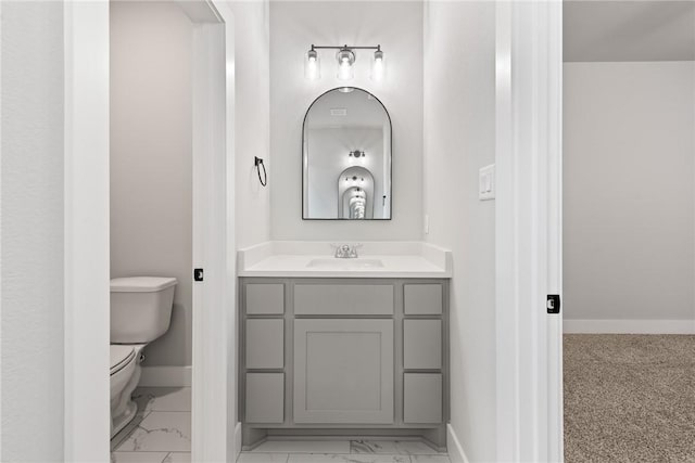 bathroom featuring vanity and toilet