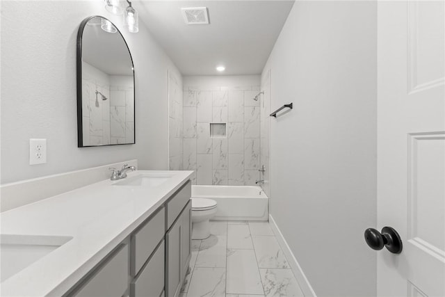 full bathroom with toilet, vanity, and tiled shower / bath