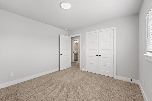 unfurnished bedroom featuring multiple windows, a closet, and carpet floors