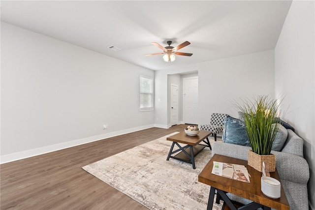 living room with hardwood / wood-style floors and ceiling fan