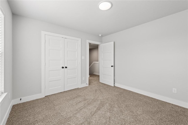 unfurnished bedroom featuring carpet floors and a closet