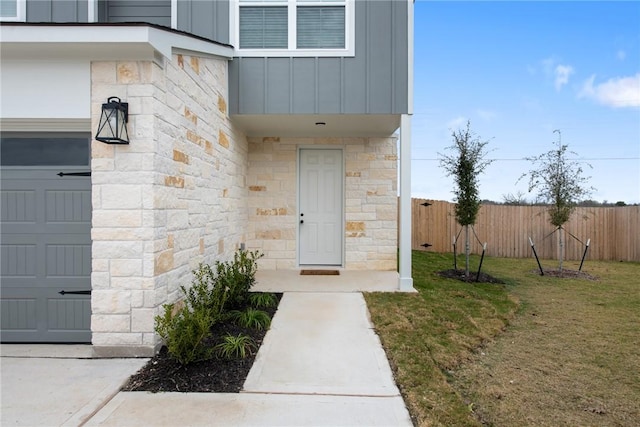 view of exterior entry with a lawn