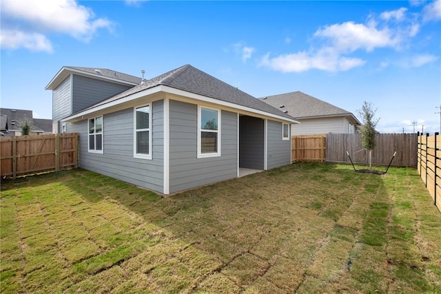 rear view of property with a lawn