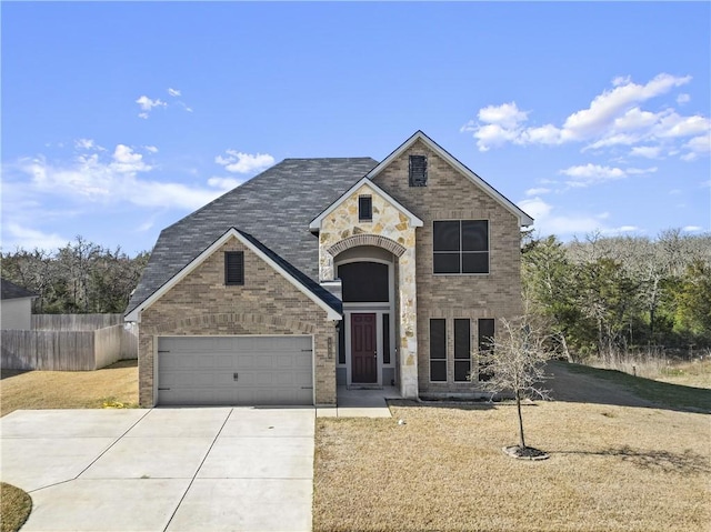 traditional home featuring a garage, driveway, brick siding, and fence