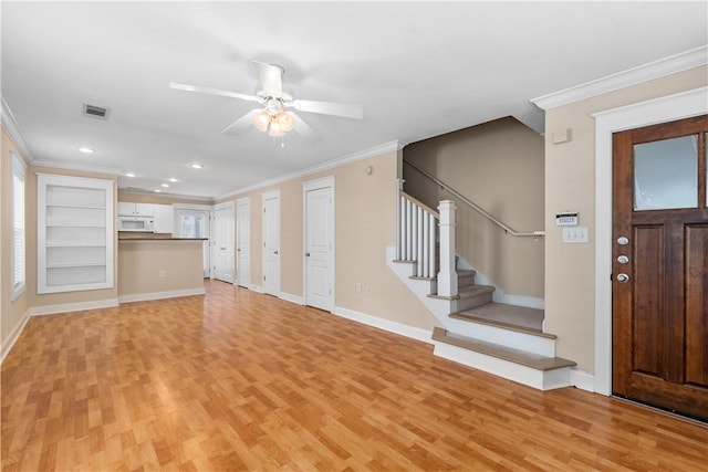 unfurnished living room with ceiling fan, crown molding, and light hardwood / wood-style flooring