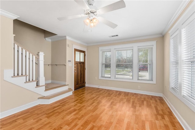 foyer featuring ceiling fan, crown molding, and light hardwood / wood-style flooring