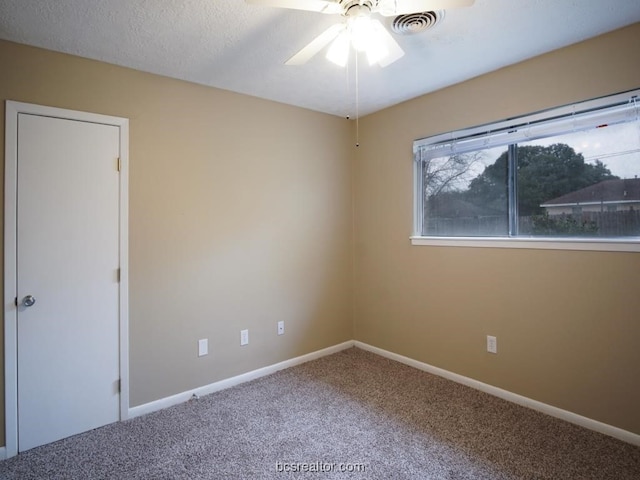 carpeted empty room with a textured ceiling and ceiling fan