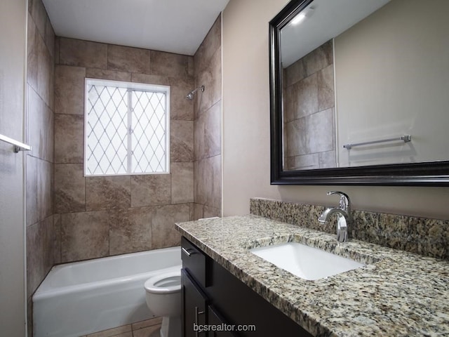 full bathroom featuring tiled shower / bath combo, toilet, and vanity