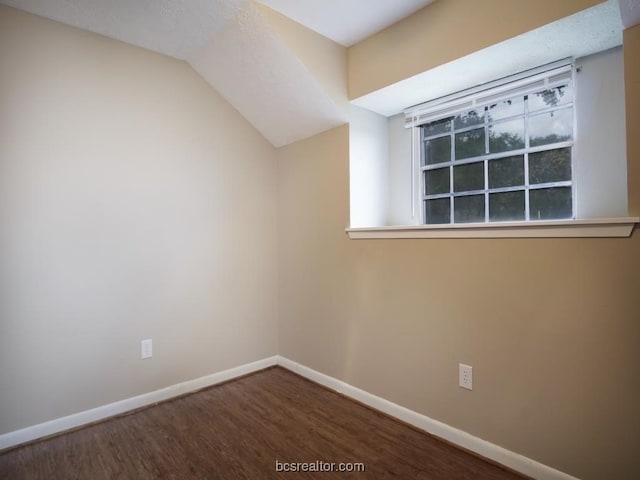 unfurnished room with wood-type flooring and lofted ceiling