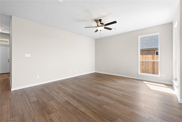 unfurnished room with ceiling fan, baseboards, and wood finished floors