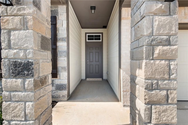 doorway to property featuring stone siding