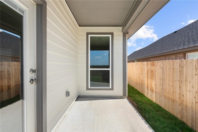 entrance to property featuring fence