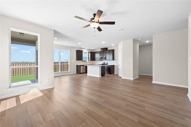 unfurnished living room featuring visible vents, baseboards, ceiling fan, light wood-type flooring, and recessed lighting