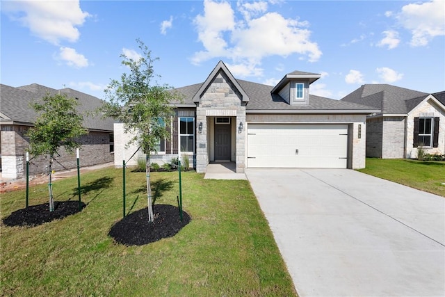 view of front of home with an attached garage, stone siding, driveway, roof with shingles, and a front yard